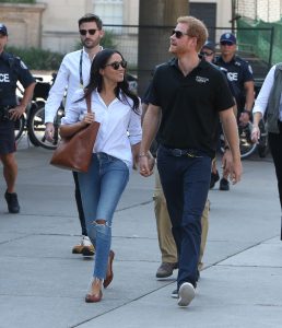 Prince Harry and Meghan Markle stroll hand-in-hand. (Photo by Splash News)